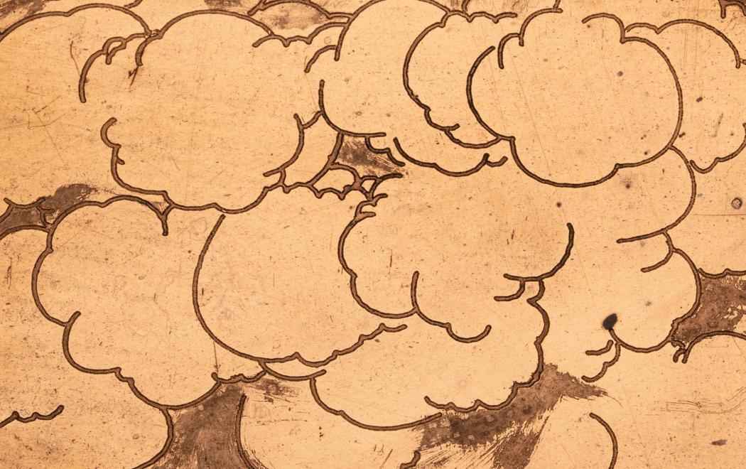 Cartoon clouds form a mass on a copper surface